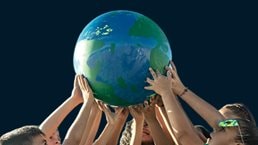 Children holding a planet outdoors - stock photo