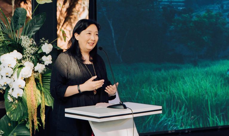 Phillia Wibowo speaking at podium