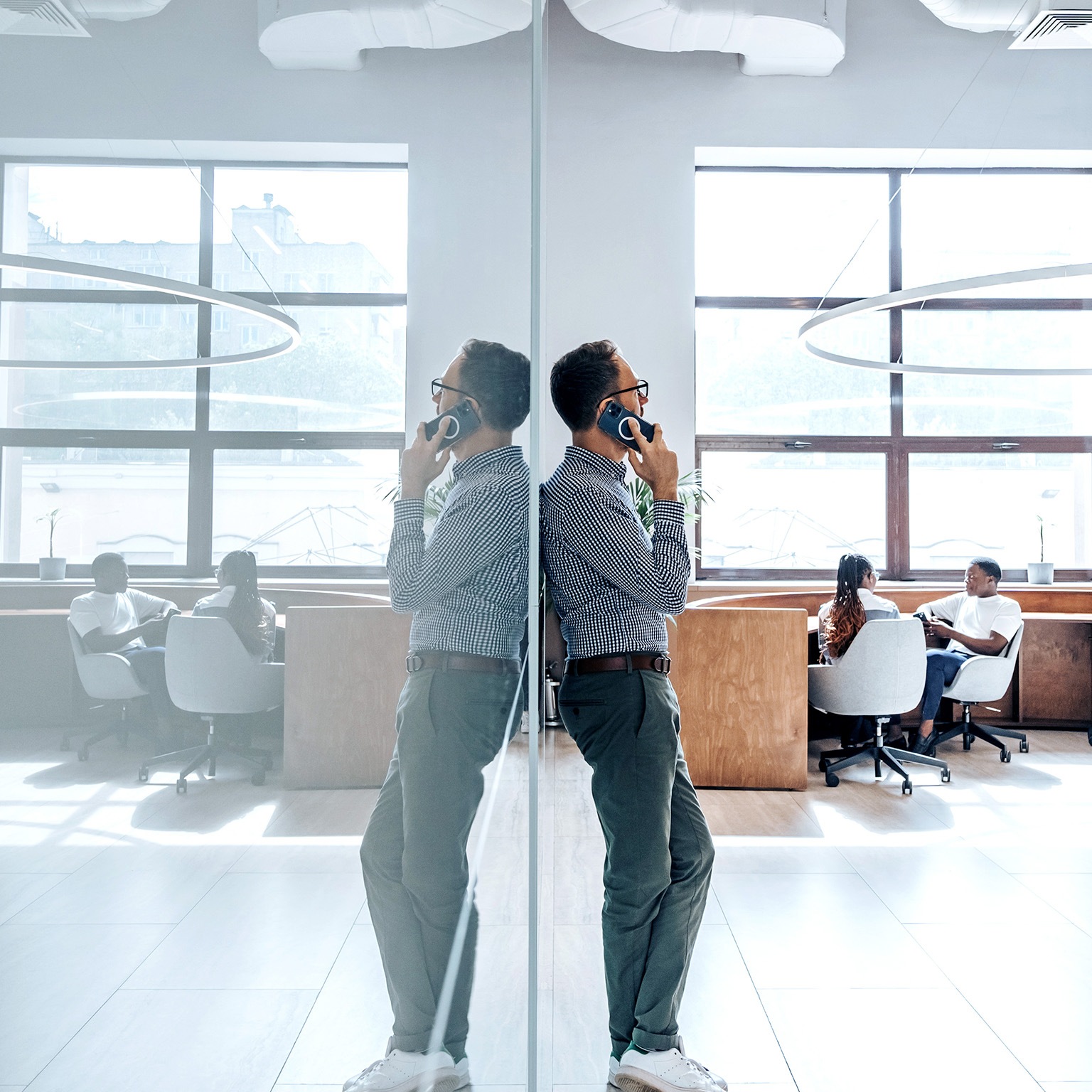 Businessman talking on phone in office.