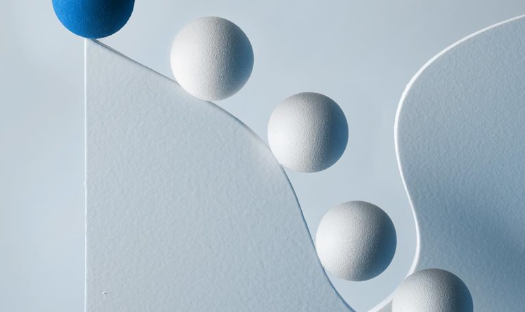 Several spheres following lead sphere along curvaceous path upward. - stock illustration