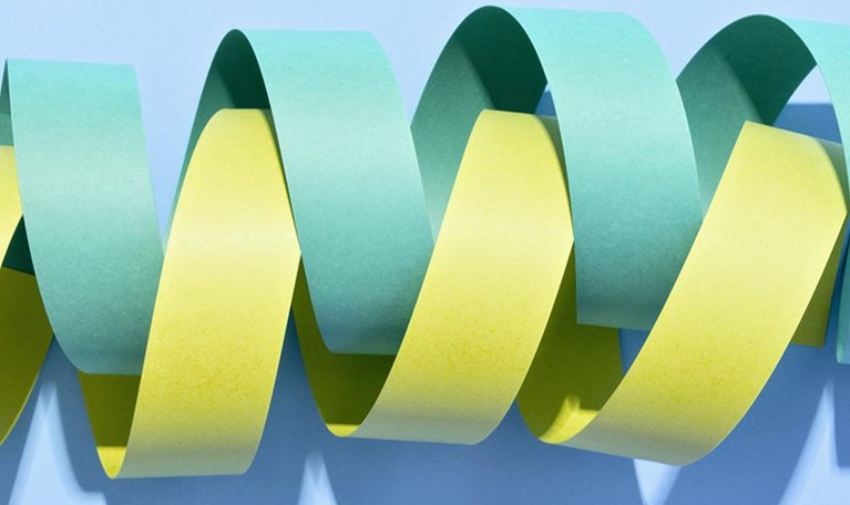 Two twisted paper stripe coils wrapped in helix shape. - stock photo