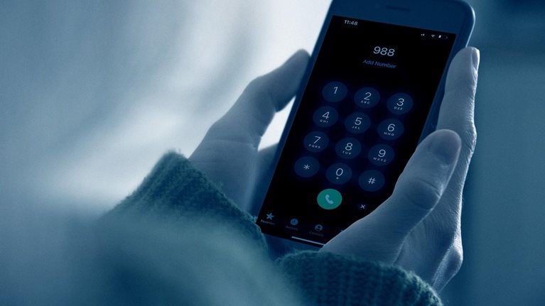 Woman looking at blank smart phone screen in the dark at night - stock photo