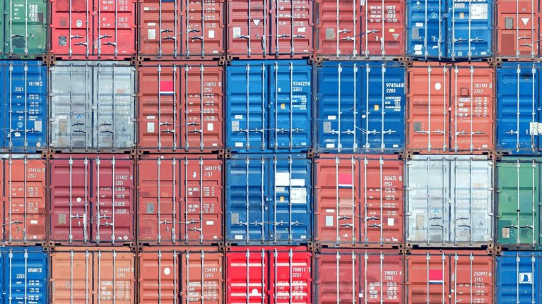 None Stacked shipping containers filling the image from edge to edge.