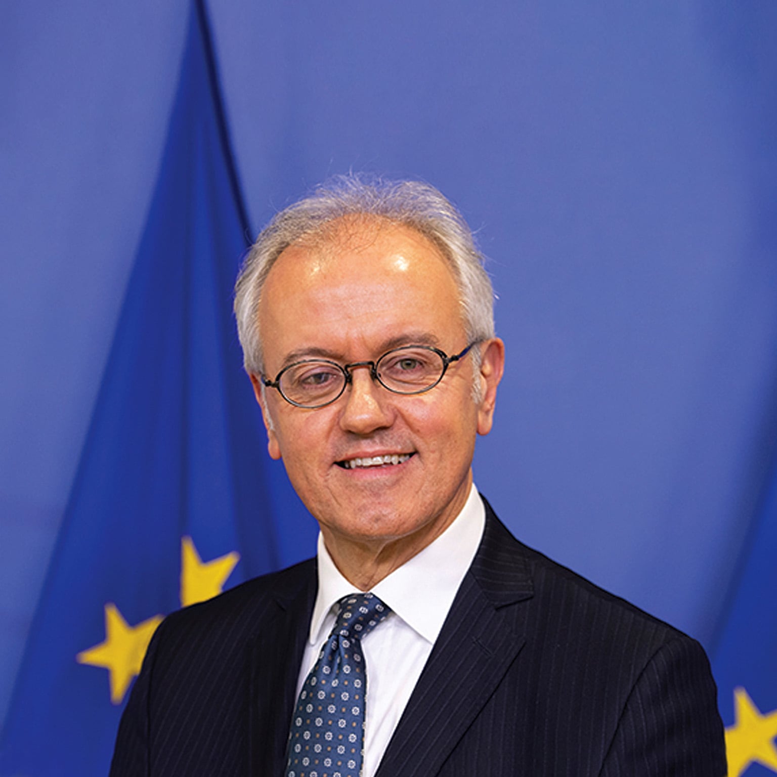  Portrait of Marco Buti photographed in front of a United Nation flag.