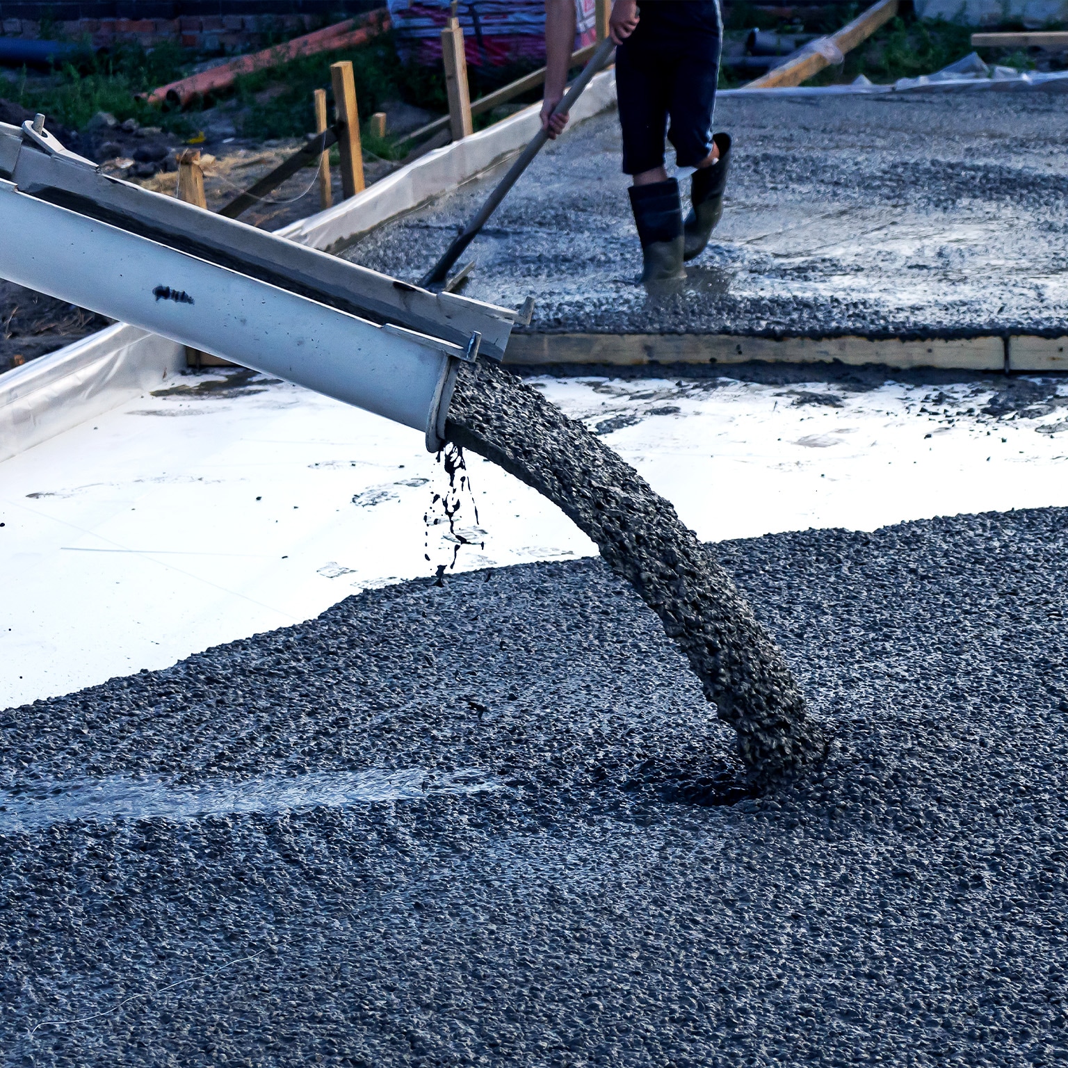  Image of a mobile concrete mixer being used to pour the foundation for construction of a residential building.