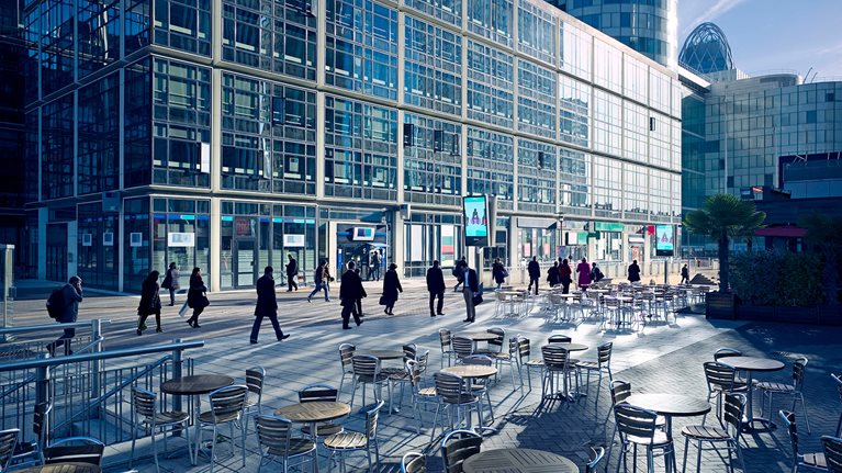 Businesspeople walk though a mixed-use development in La Defense business district of Paris, France, during their morning commute.