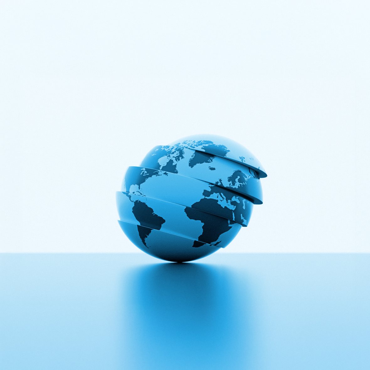 A stylized blue globe with continents visible, divided into several horizontal slices slightly separated from each other. The sphere tilts gently to one side as the layers appear to float above a smooth surface, creating a modern, futuristic look.