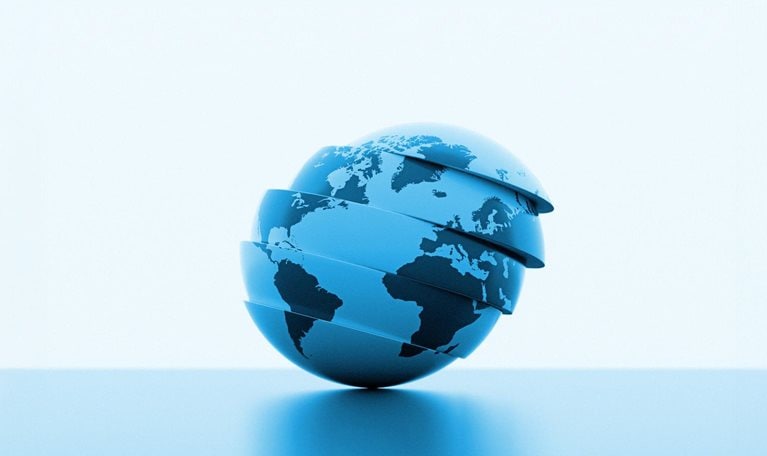 A stylized blue globe with continents visible, divided into several horizontal slices slightly separated from each other. The sphere tilts gently to one side as the layers appear to float above a smooth surface, creating a modern, futuristic look.