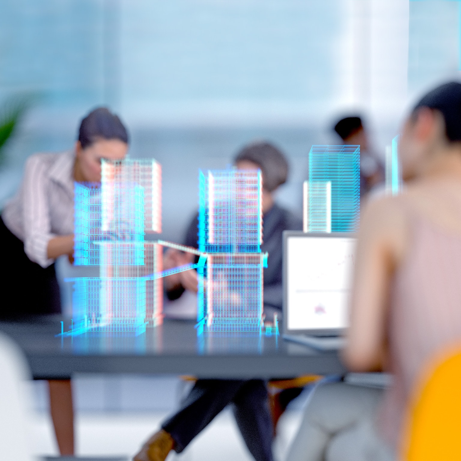 Engineers and architects working in a modern office with a building project visualized with augmented reality software. 