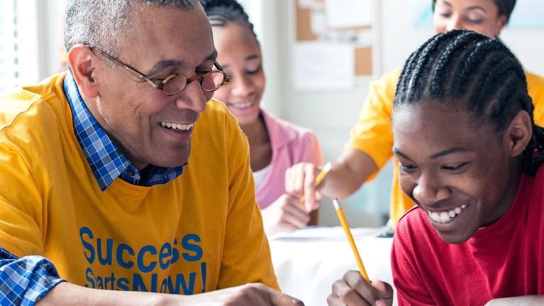 Senior Volunteers tutoring students in classroom