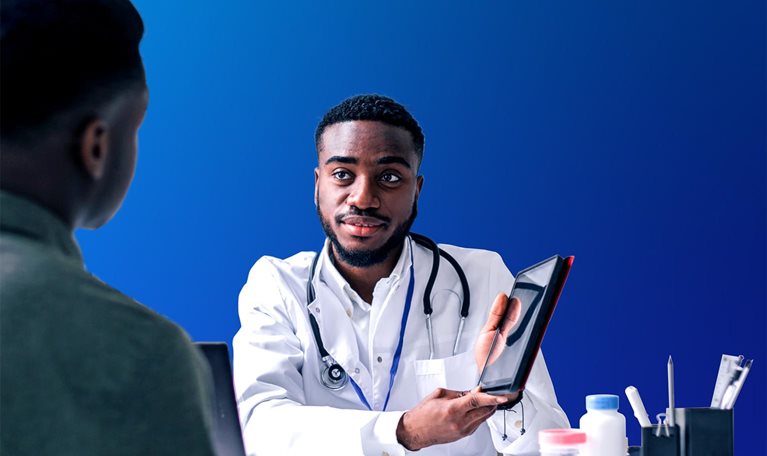 Young African man having an African-American man doctor's appointment at medical clinic.