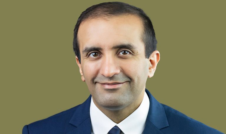 Portrait of Raj Panjabi with an easy smile and a blue suit.