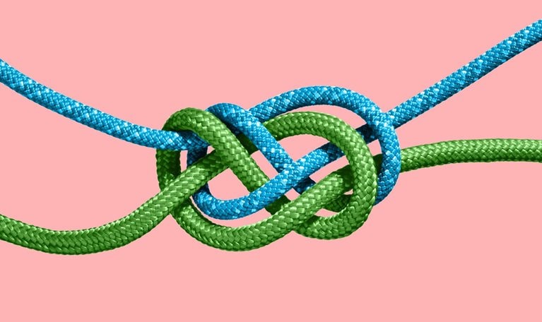 Two colored ropes knotted together.