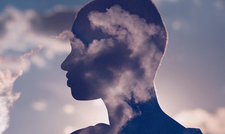 Photo illustration of a woman's silhouette enhanced by clouds