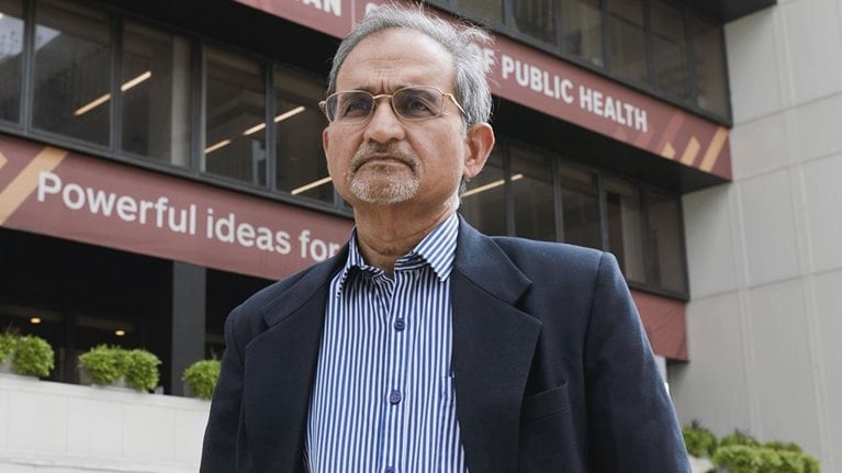 Dr. Shekhar Saxena stands in front of Harvard’s T.H. Chan School of Public Health. Photo by Kent Dayton