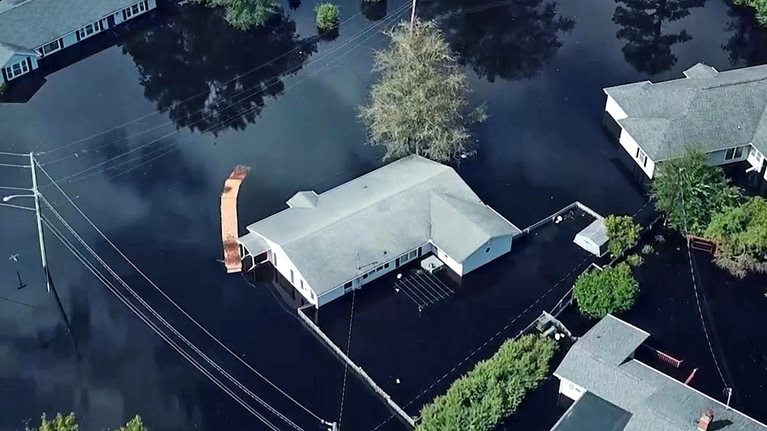 Homes surrounded by flood water in South Carolina after a hurricane.