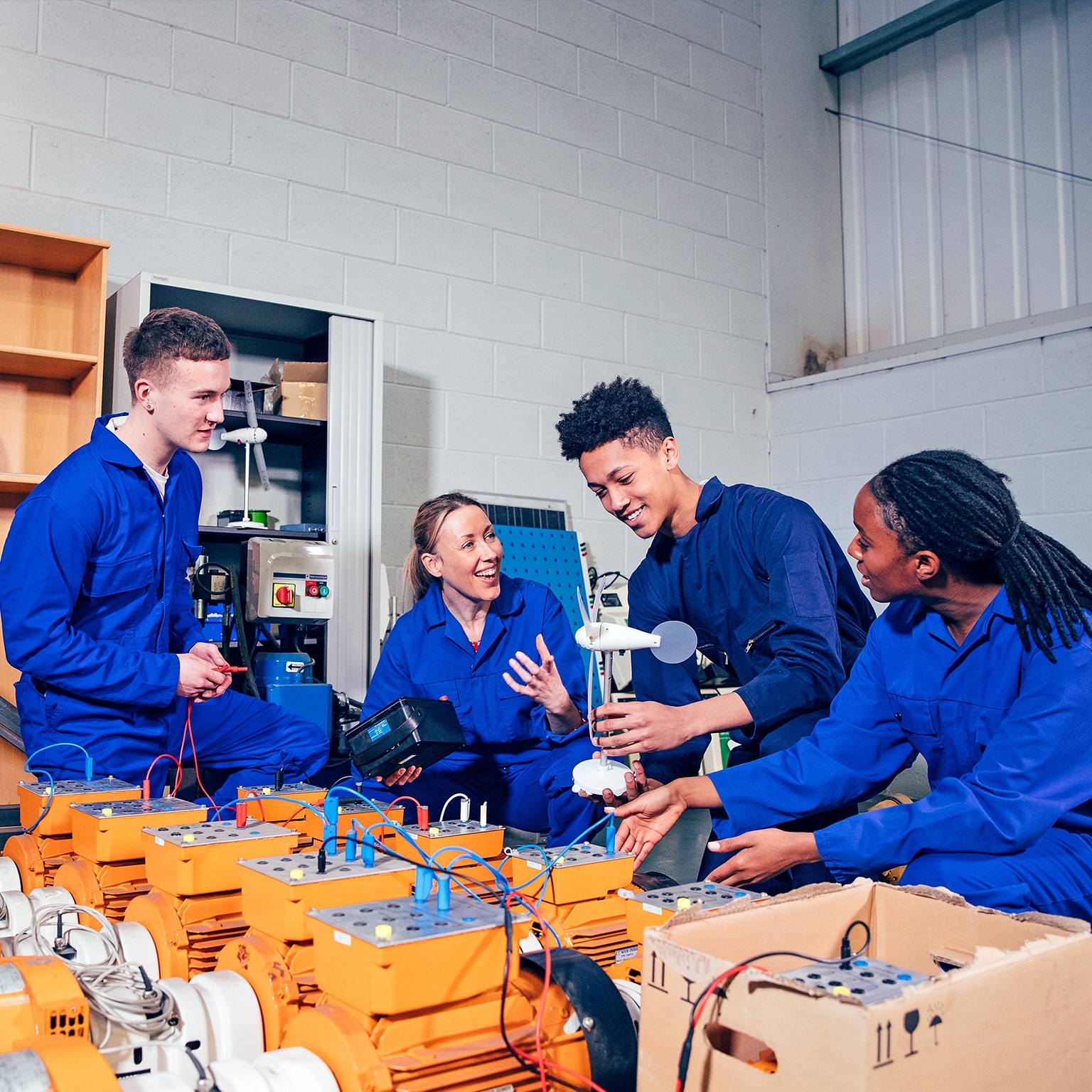 Four high schoolers work on an engineering project together