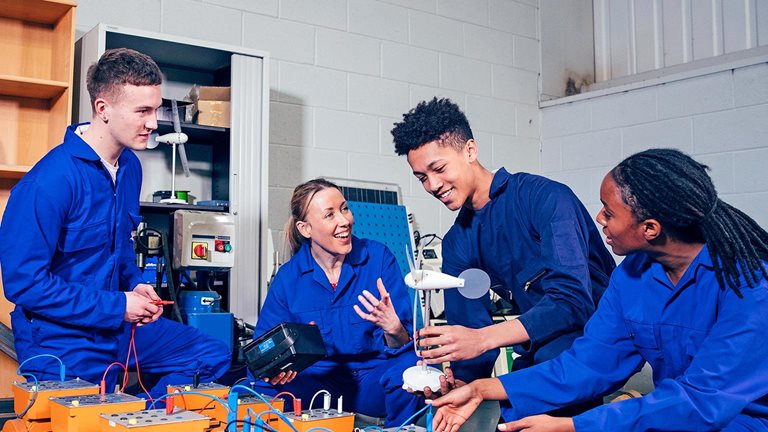 Four high schoolers work on an engineering project together