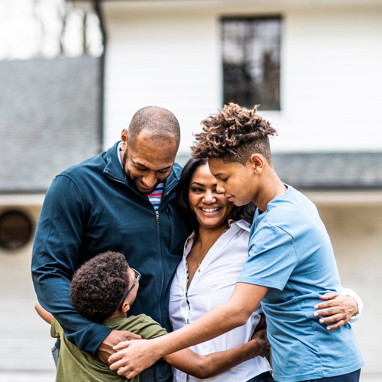 Portrait of family in front of residential home