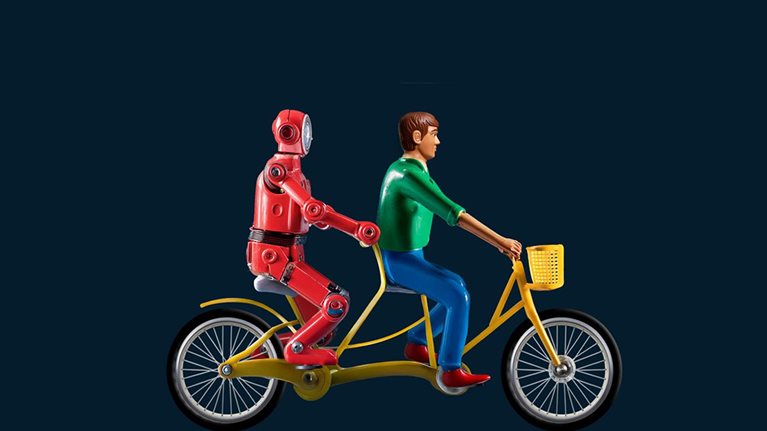 A 3D rendering of two toylike figures riding a tandem bicycle. The figure in the front seat is a person, representing a human worker. A robot, representing AI, sits in the back seat, pedaling the bike along with the human worker.