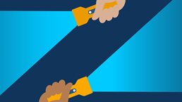 Two different hands, one on the bottom and one on the top edge of the image, each holding a lit flashlight. The negative space where the light beams don’t shine forms the letter “Z.”