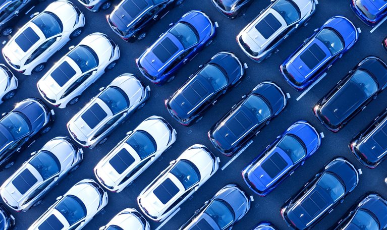 Aerial view of cars parked in many rows