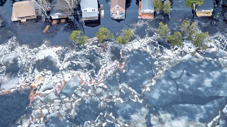Huge chunks of ice propelled by wind and flood waters threaten cottages on Grand Lake, New Brunswick, Canada.