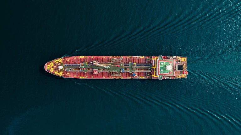 Aerial top view oil ship tanker carrier oil from refinery for transportation on the sea. - stock photo